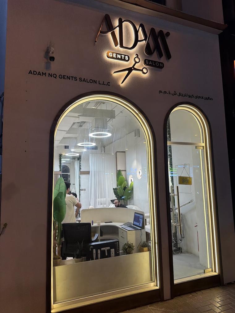 The Adam NQ shopfront lit up at night on Jumeirah Beach Road